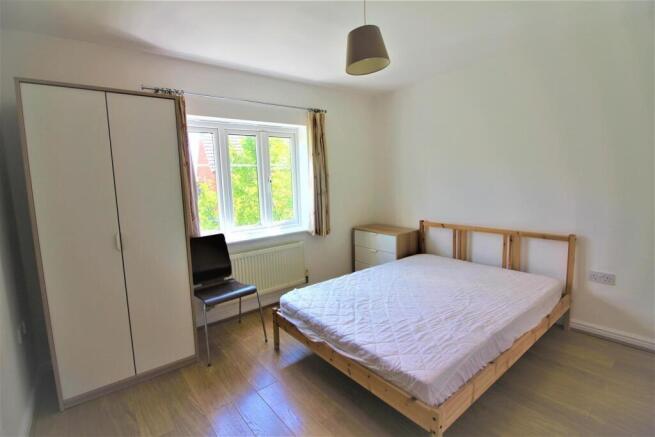 This inviting double bedroom features a spaciou...