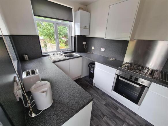 Modern kitchen featuring sleek cabinetry and am...