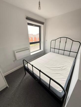 Cozy double bedroom featuring a stylish black m...