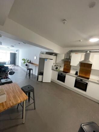 Spacious and modern kitchen featuring sleek whi...