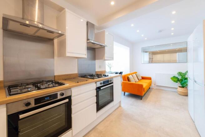 This modern kitchen features sleek cabinetry, s...