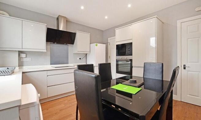 This modern kitchen features sleek cabinetry, a...
