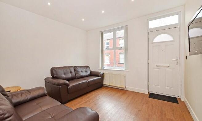 A bright and inviting living room featuring com...