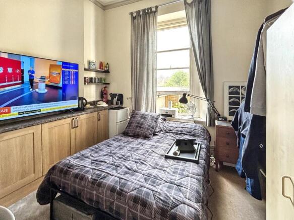 A cozy double bedroom featuring a comfortable b...
