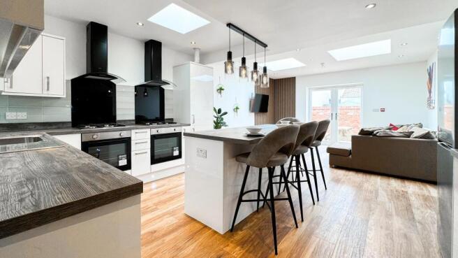 This modern kitchen features sleek cabinetry an...