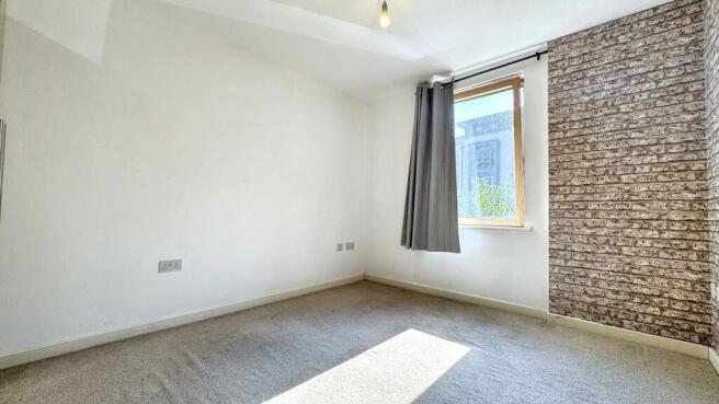 This charming double bedroom features ample nat...