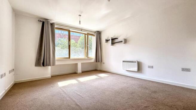 A bright and inviting living room featuring lar...