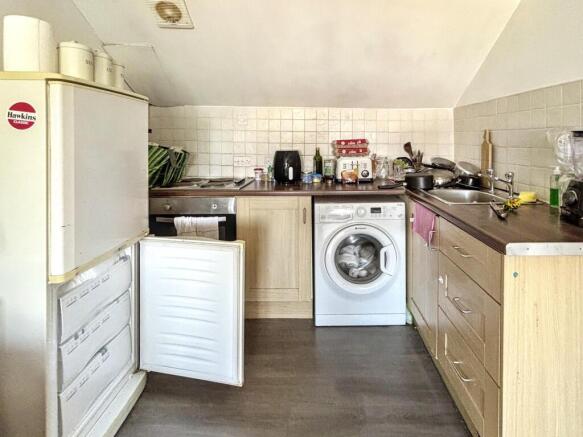 This cozy kitchen features essential appliances...