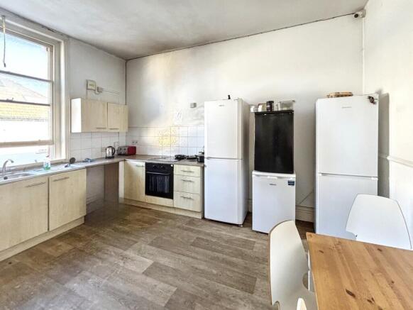 Spacious kitchen featuring modern appliances an...