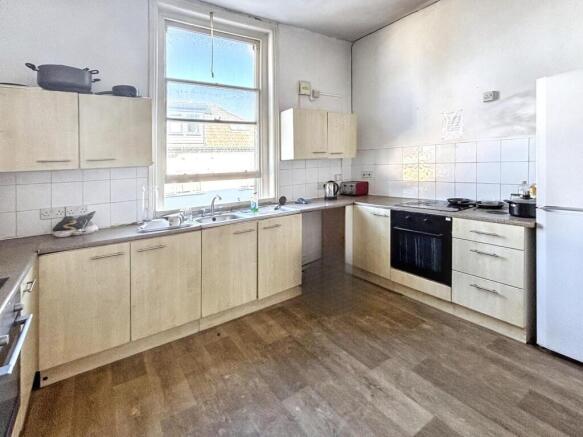 Spacious and well-lit kitchen featuring modern ...