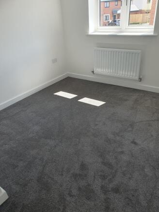 This inviting double bedroom features ample nat...
