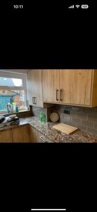 This modern kitchen features stylish wooden cab...