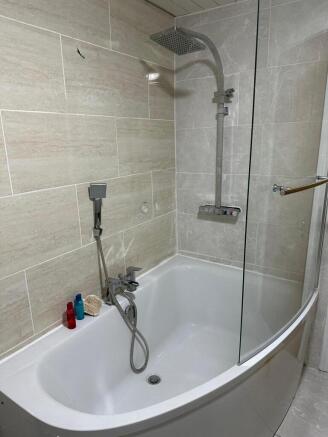 A beautifully designed bathroom featuring a mod...