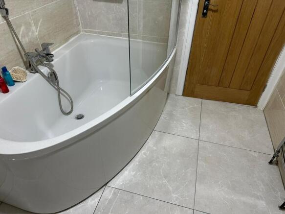 This stylish bathroom features a sleek, modern ...