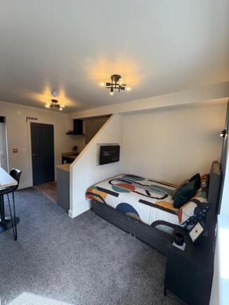 This modern double bedroom features a cozy layo...