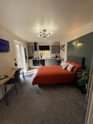 This charming double bedroom features a cozy la...