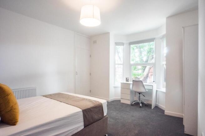 Bright and spacious double bedroom featuring la...