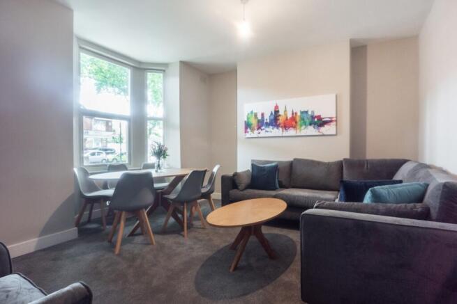 A bright and inviting living room featuring a c...