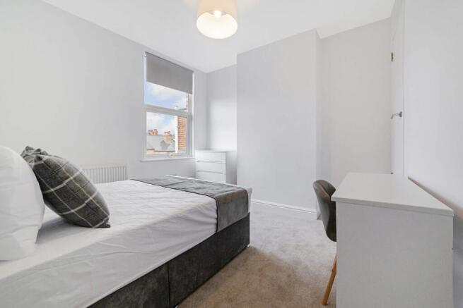 This inviting double bedroom features ample nat...