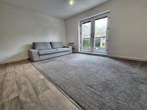 This contemporary living room features a spacio...