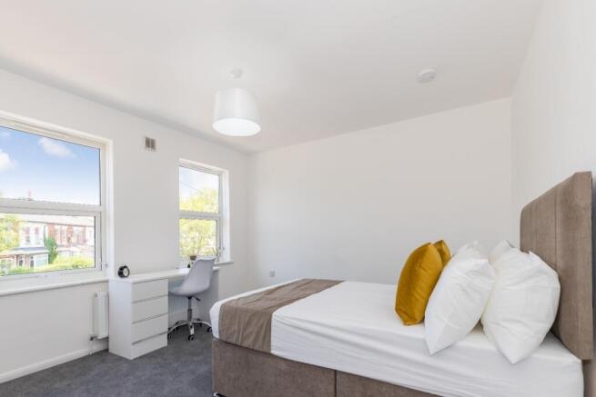 Bright and inviting double bedroom featuring am...