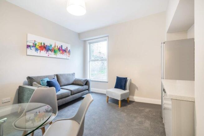 A stylish and contemporary living room featurin...