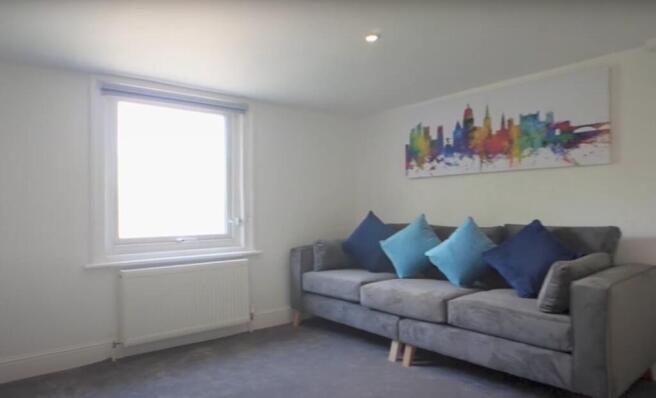Bright and inviting living room featuring a com...