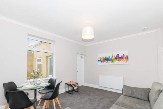 A bright and inviting living room featuring a c...