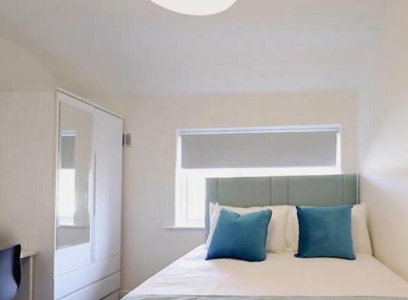 This inviting double bedroom features a cozy la...