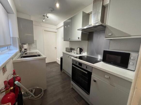Modern kitchen equipped with sleek cabinets and...
