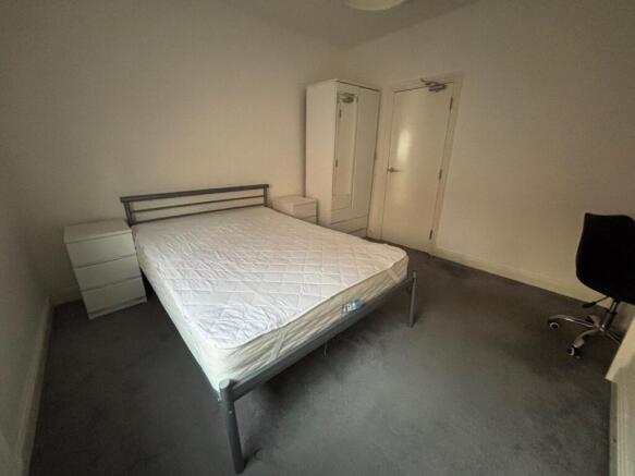 Spacious double bedroom featuring a comfortable...
