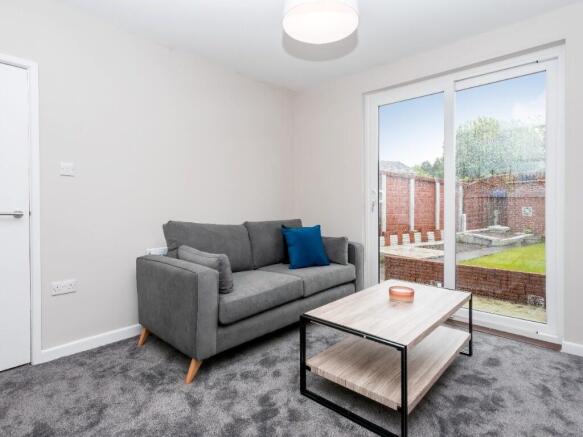 This inviting living room features a cozy sofa ...