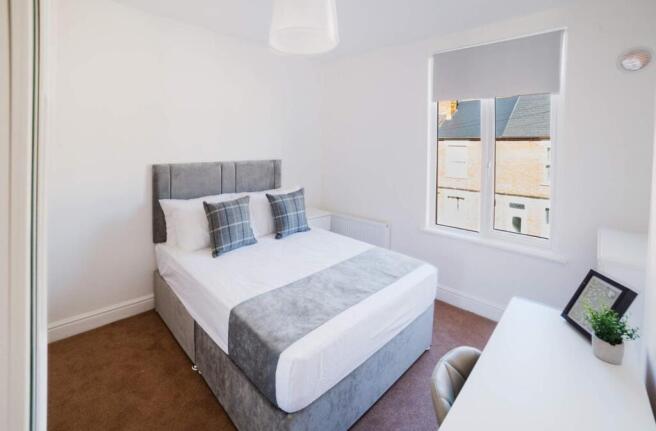 Bright and inviting double bedroom featuring a ...