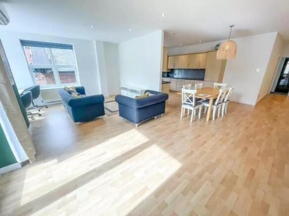 Spacious and bright living room featuring conte...