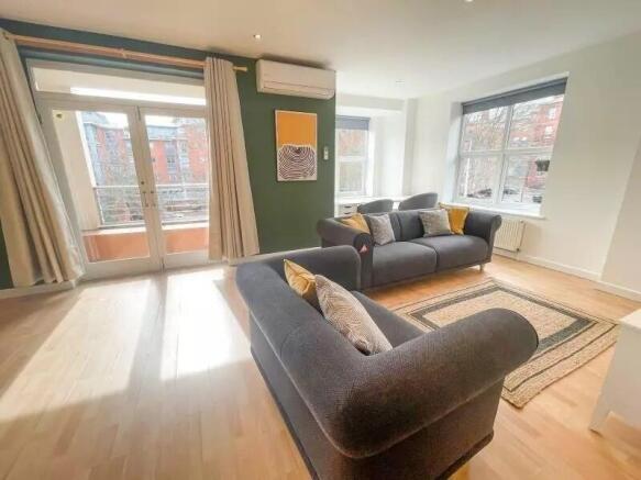 Bright and inviting living room featuring large...