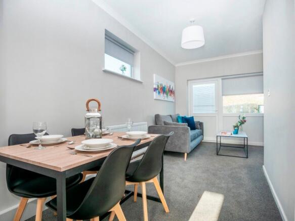 A bright and inviting living room featuring a c...