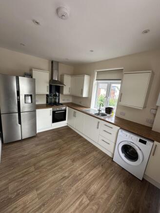 A modern kitchen featuring ample counter space,...