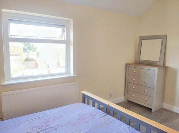 Bright and welcoming master bedroom featuring a...