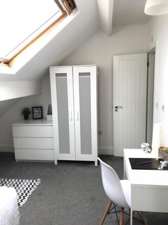 This inviting double bedroom features ample nat...