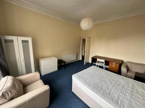 A spacious and inviting double bedroom with amp...
