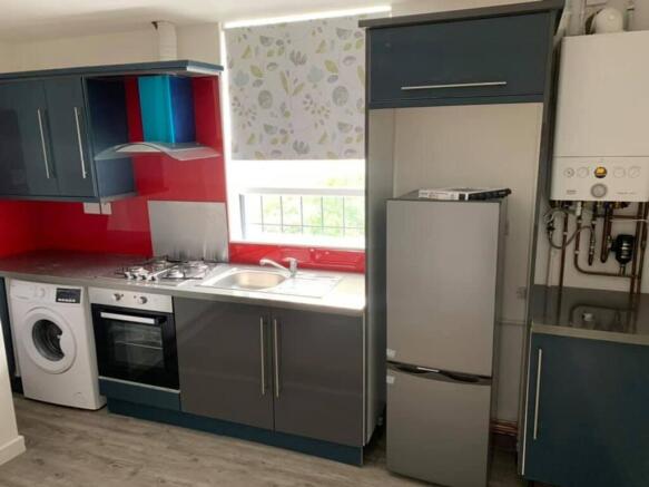 A modern kitchen with ample storage and applian...