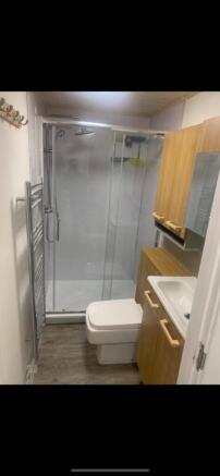 A modern and clean bathroom featuring a shower,...