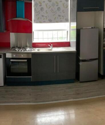 A tidy kitchen with modern appliances and a win...