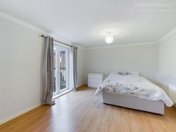 Spacious double bedroom featuring large windows...