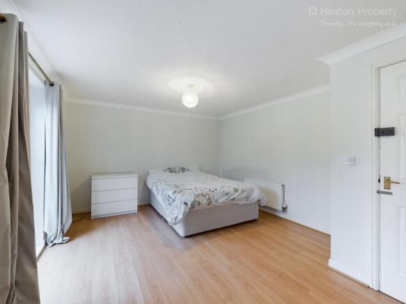 Spacious double bedroom featuring a comfortable...