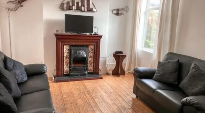 A cozy living room featuring two black leather ...