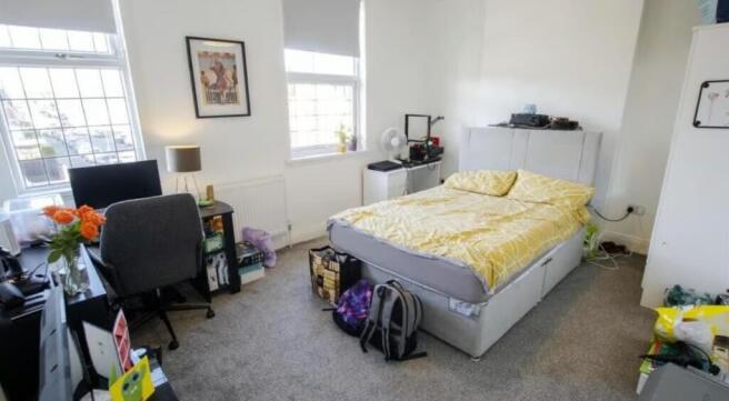 Bright and cozy double bedroom featuring large ...