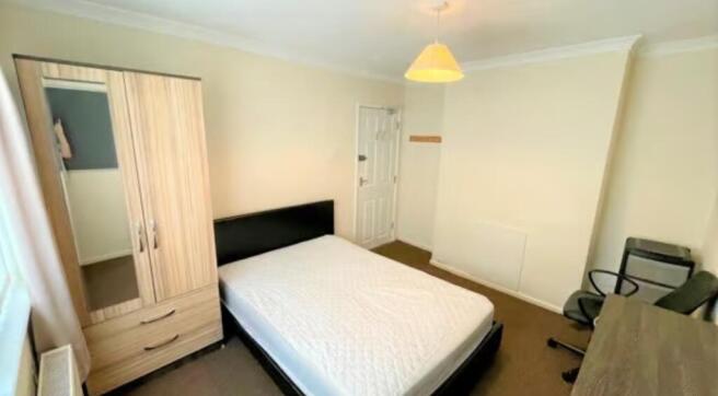 A tidy and inviting double bedroom featuring a ...