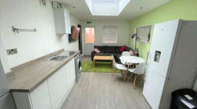 Bright and modern living area with a sleek kitc...