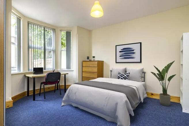 A bright and welcoming double bedroom featuring...